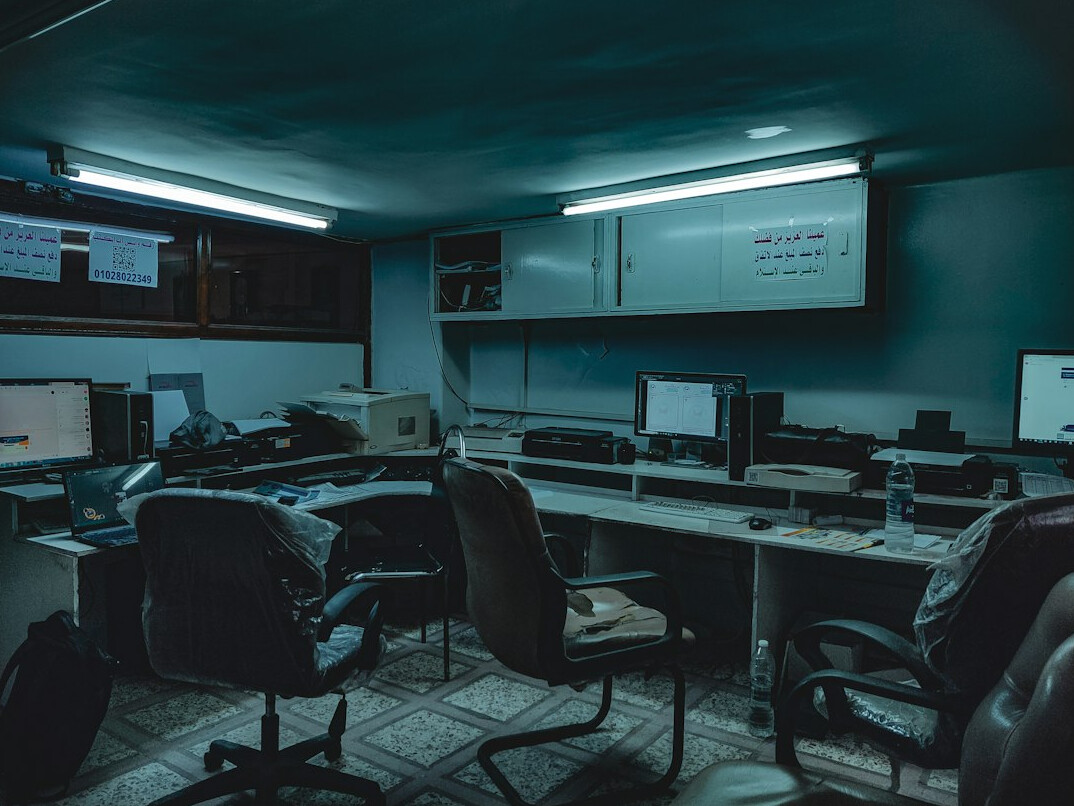 Empty broadcast control room with many monitors and mixing console